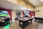 This one of a kind Harry Potter theme games room with a pool table, a air hockey table, a golden tee golf, and multi-arcade system